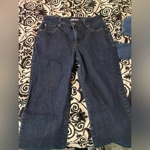 These are some blue bootcut jeans with a design in the back and little diamonds